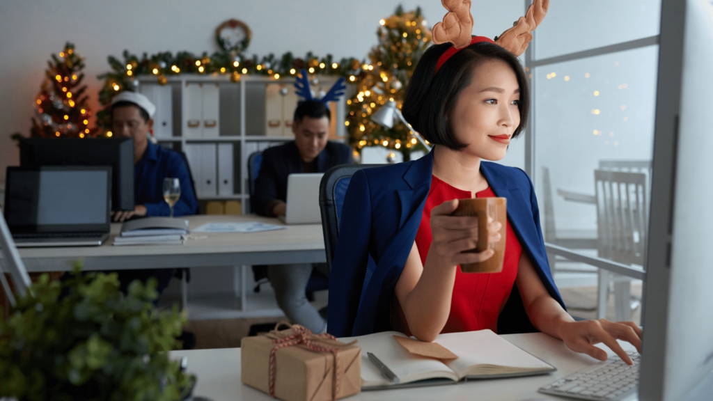 Image of coworkers in office wearing reindeer antlers